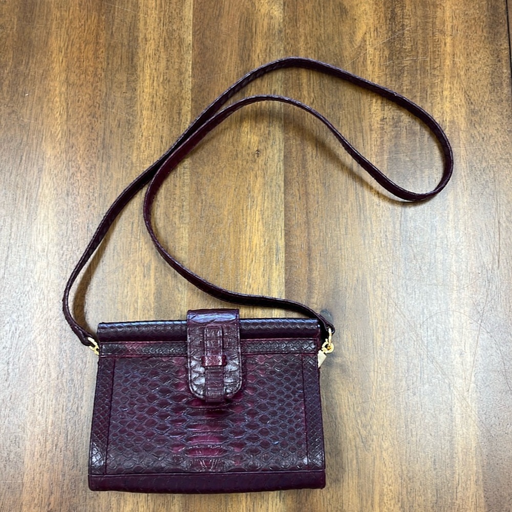 Ximena Kavalekas burgundy mini crossbody/clutch.